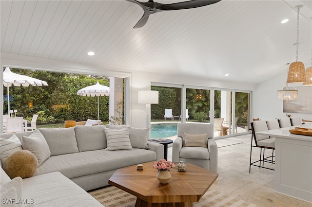 living area with ceiling fan with notable chandelier and recessed lighting