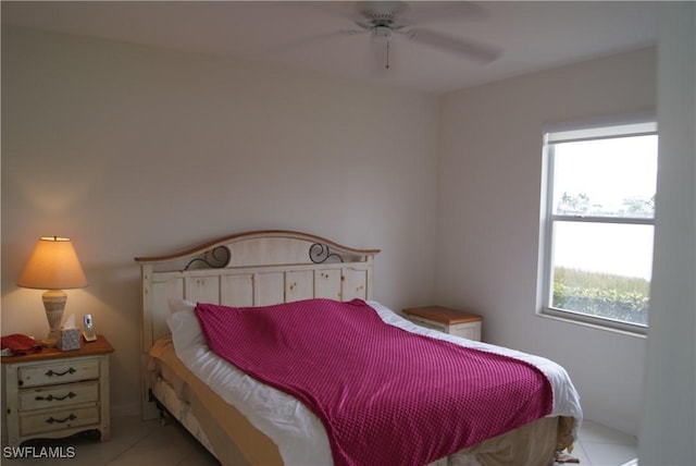 bedroom featuring multiple windows, ceiling fan, and light tile patterned flooring