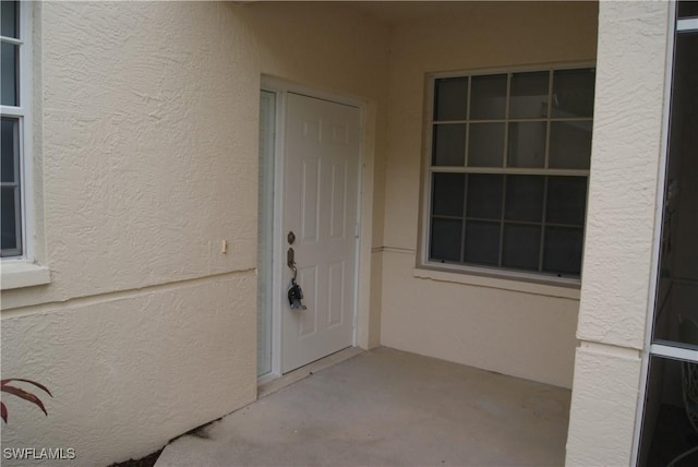 doorway to property featuring a patio