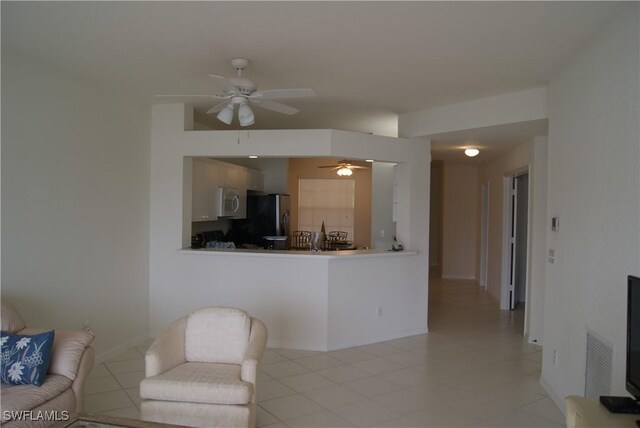 living room featuring light tile patterned floors and ceiling fan