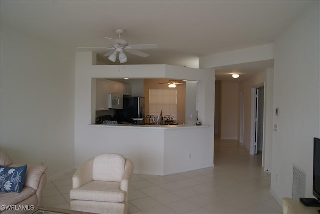 living room featuring light tile patterned flooring and ceiling fan