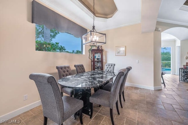 dining area with crown molding and an inviting chandelier