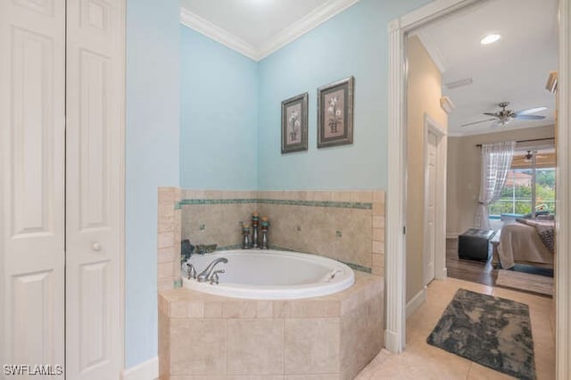 bathroom with ceiling fan, a relaxing tiled tub, crown molding, and tile patterned flooring