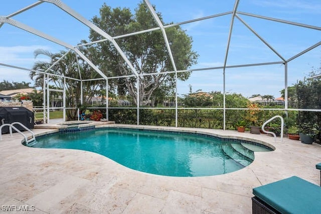 view of swimming pool with glass enclosure and a patio area