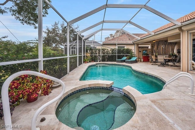 view of pool with an in ground hot tub, a lanai, and a patio