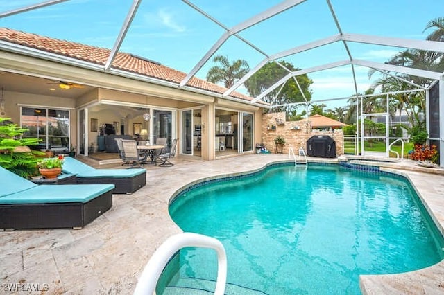 view of swimming pool featuring a patio, glass enclosure, and a grill