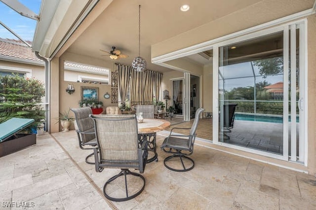 view of patio / terrace featuring ceiling fan and a lanai