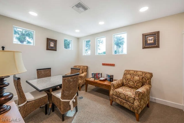 carpeted dining area featuring plenty of natural light