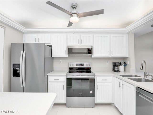 kitchen featuring white cabinetry, sink, light tile patterned floors, ceiling fan, and stainless steel appliances