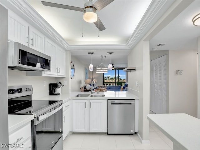 kitchen with stainless steel appliances, a sink, and light countertops