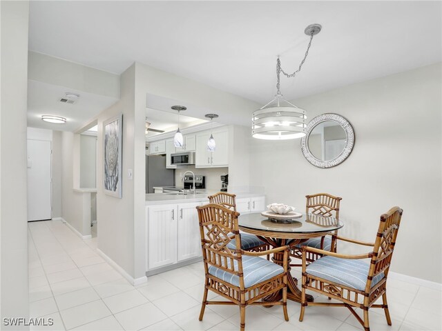 dining room featuring light tile patterned flooring and sink