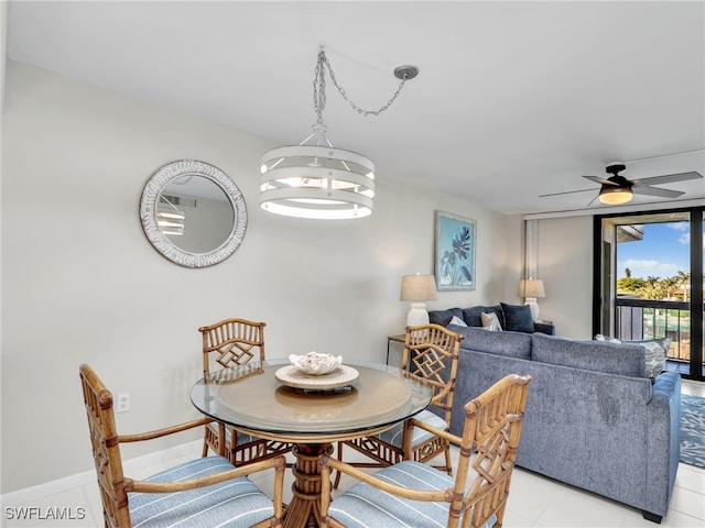 dining room with ceiling fan with notable chandelier and light tile patterned floors