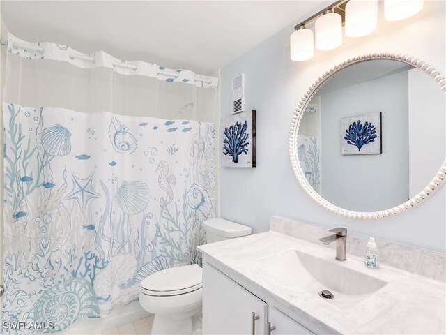 bathroom featuring vanity, toilet, and curtained shower