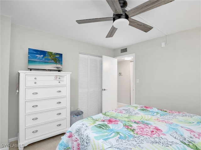 bedroom featuring light carpet, a closet, and ceiling fan