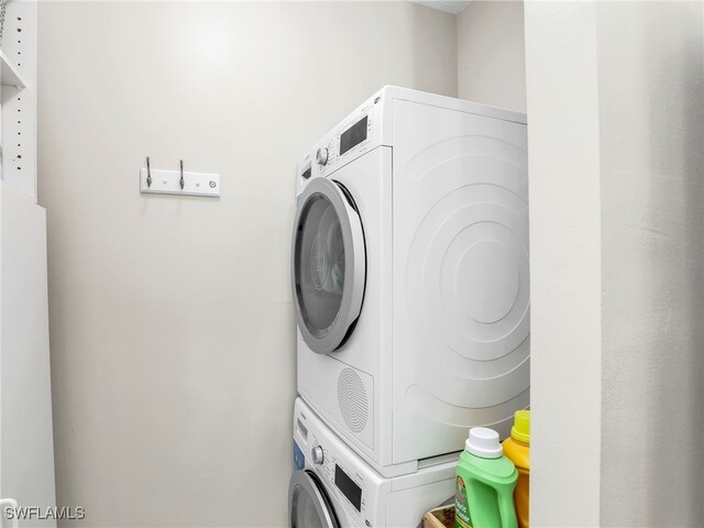 laundry room with stacked washer and clothes dryer