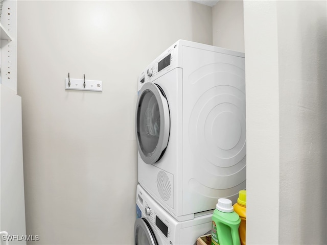 clothes washing area featuring laundry area and stacked washer / drying machine