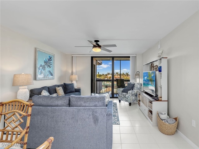 living room featuring light tile patterned floors, expansive windows, and ceiling fan