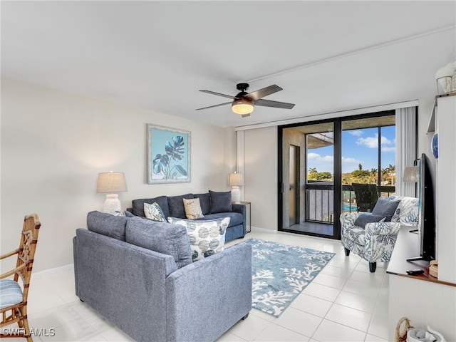 living room featuring floor to ceiling windows, light tile patterned floors, and ceiling fan