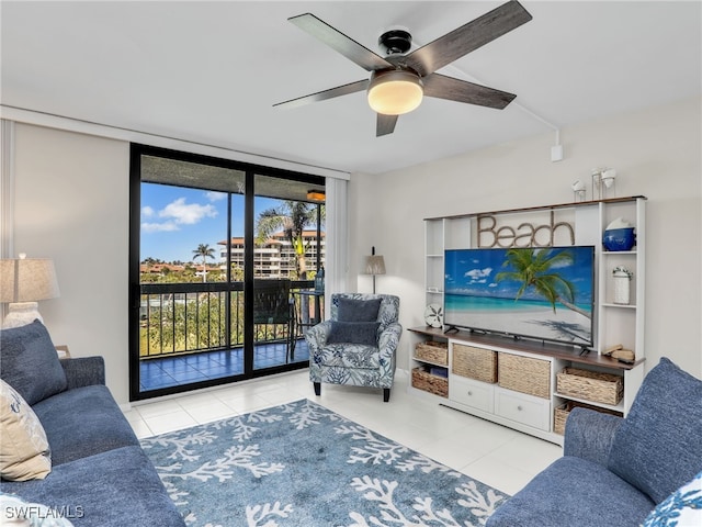 living room featuring light tile patterned floors, a wall of windows, and ceiling fan