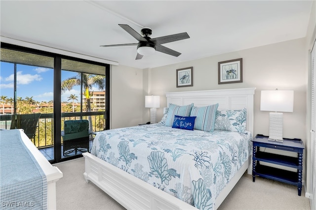 bedroom featuring a wall of windows, access to outside, light colored carpet, and ceiling fan