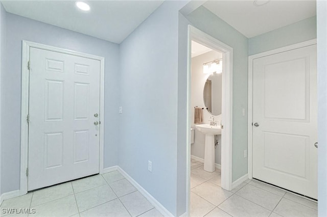 interior space featuring sink and light tile patterned floors