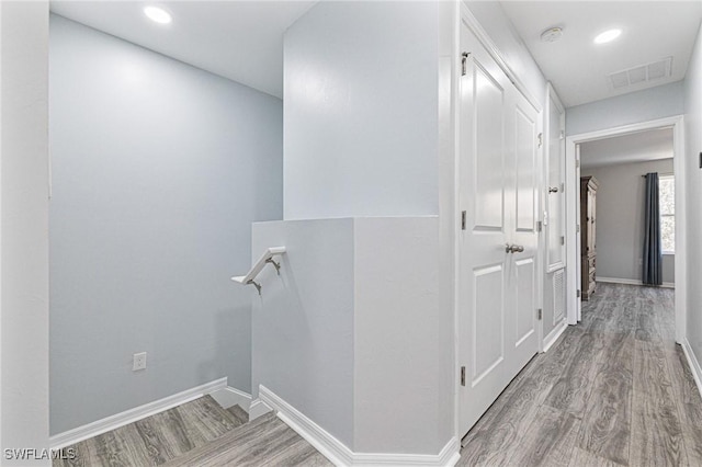 hallway with light hardwood / wood-style flooring