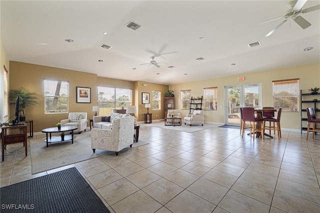 living room with vaulted ceiling, ceiling fan, and light tile patterned flooring