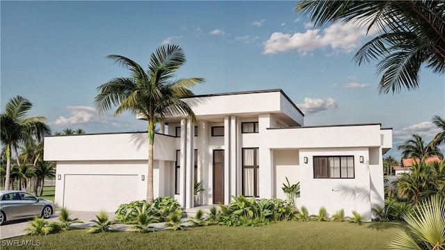 view of front of home featuring a garage and a front yard