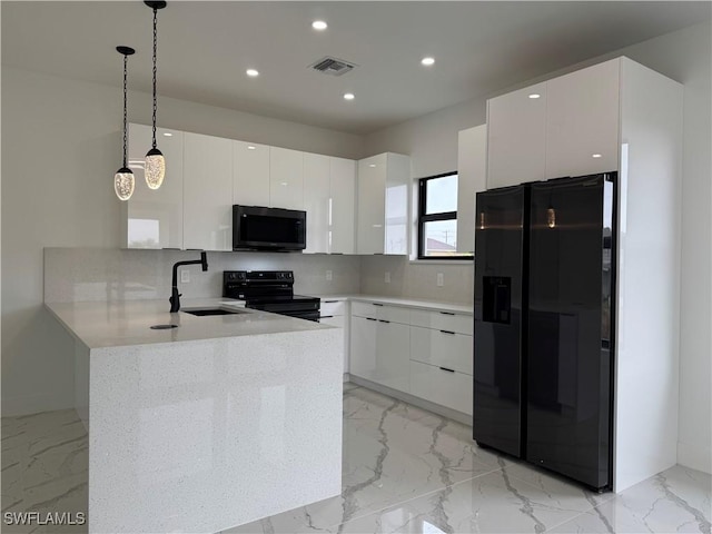 kitchen featuring sink, white cabinetry, black appliances, decorative light fixtures, and kitchen peninsula