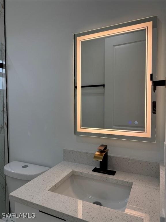 bathroom with vanity and toilet