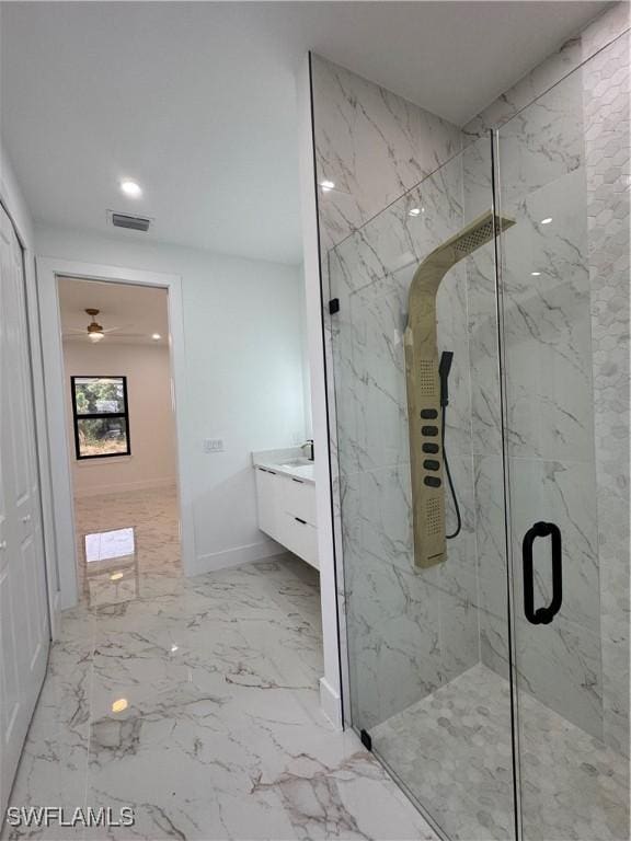 bathroom with vanity and a shower with door