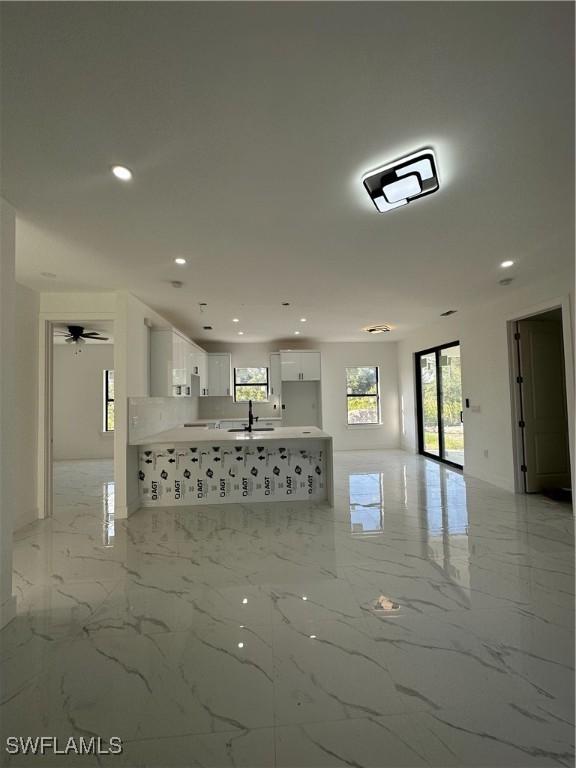 unfurnished living room featuring sink