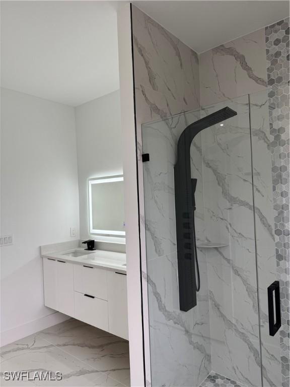 bathroom featuring vanity and a shower with door