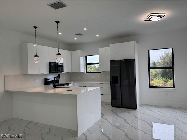 kitchen featuring white cabinetry, decorative backsplash, hanging light fixtures, and black appliances