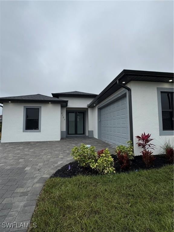 view of front of home with a garage and a front lawn