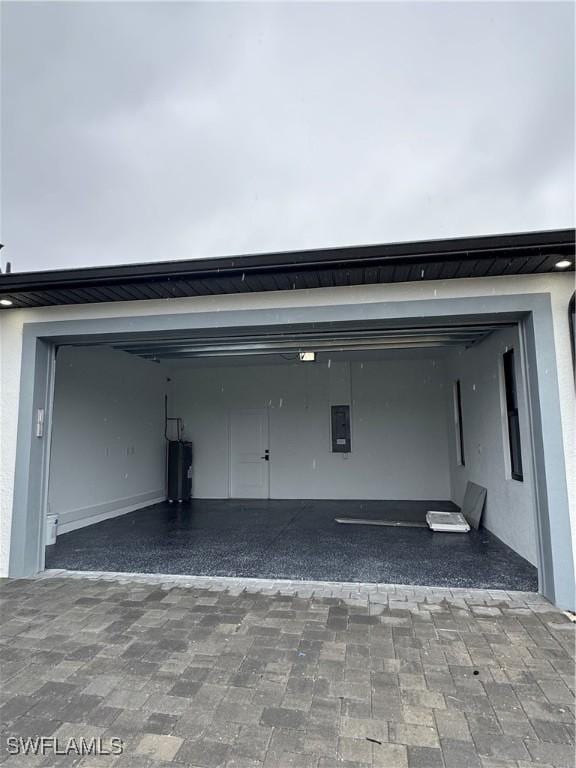 garage with electric panel and electric water heater