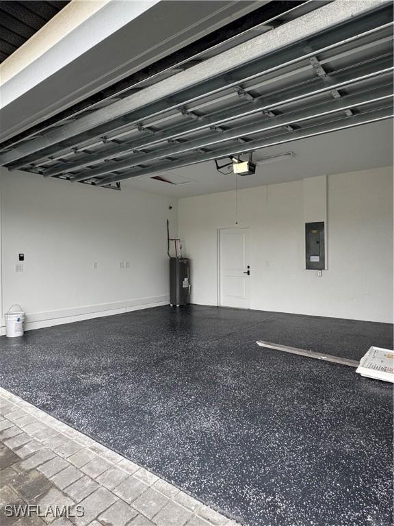 garage featuring a garage door opener, electric water heater, and electric panel