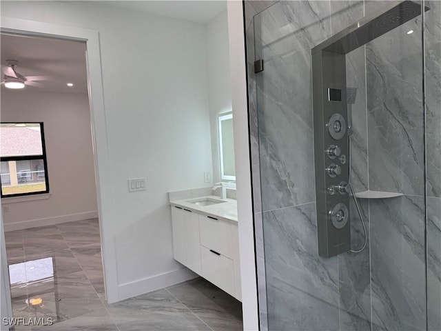 bathroom with vanity and a tile shower