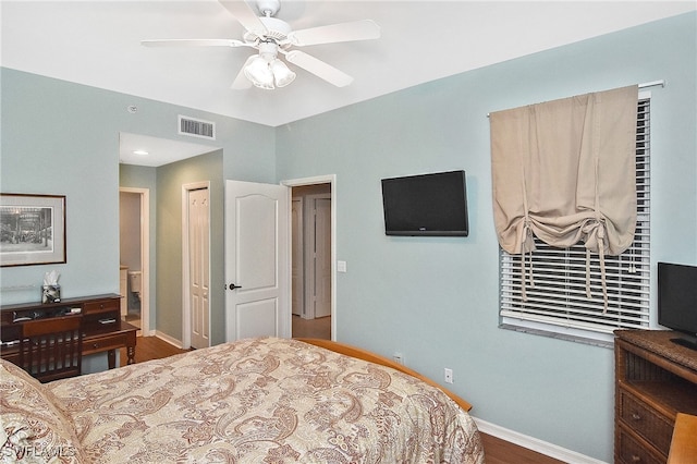 bedroom featuring baseboards, visible vents, a ceiling fan, and wood finished floors