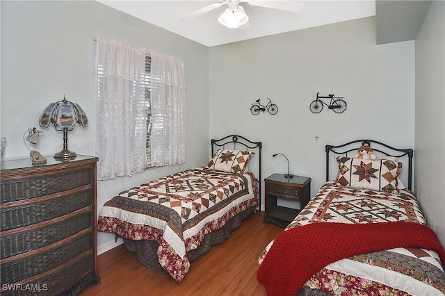 bedroom with ceiling fan and hardwood / wood-style floors