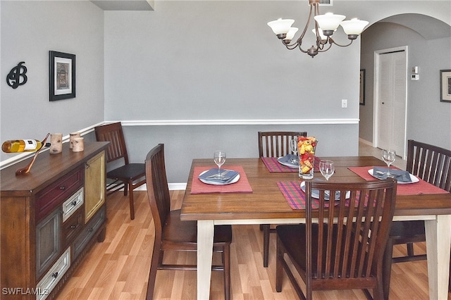 dining space with an inviting chandelier and light wood-type flooring