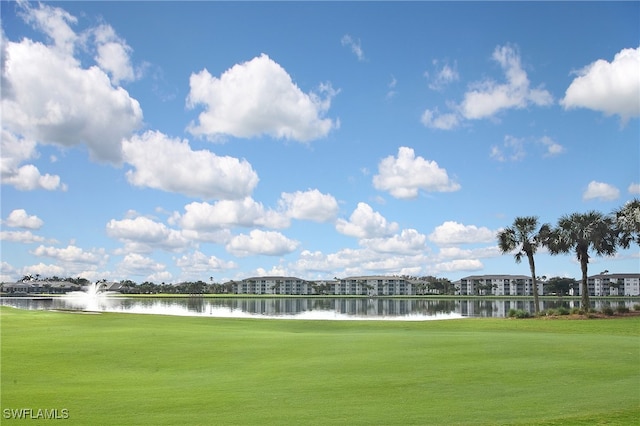 view of property's community featuring a water view and a yard