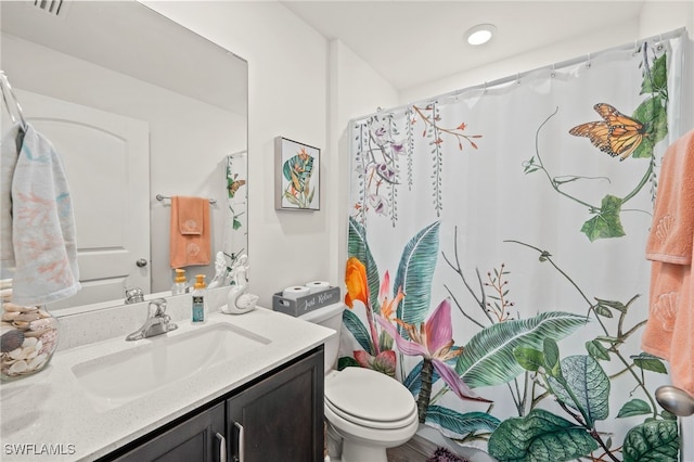 bathroom featuring vanity and toilet