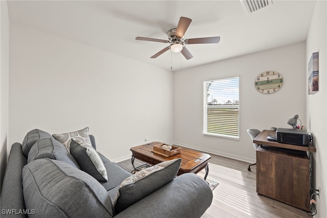 living room featuring ceiling fan and light wood-type flooring