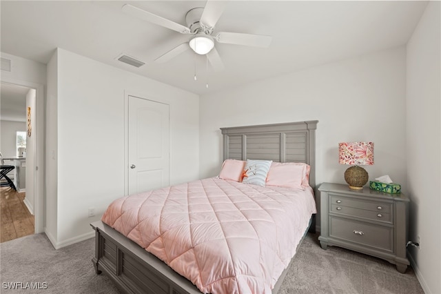 bedroom with ceiling fan and light carpet