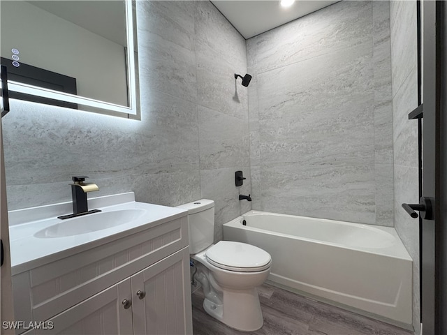 full bathroom with vanity, toilet, shower / bath combination, and hardwood / wood-style floors