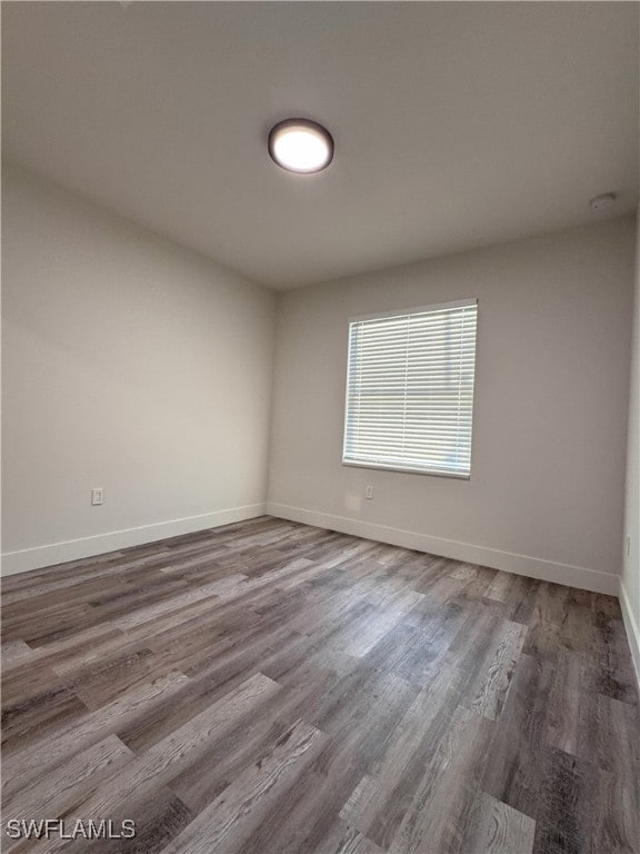 spare room with hardwood / wood-style floors