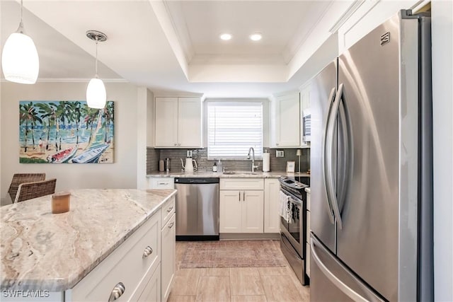 kitchen featuring sink, decorative light fixtures, stainless steel appliances, and white cabinets