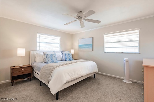 carpeted bedroom featuring crown molding and ceiling fan