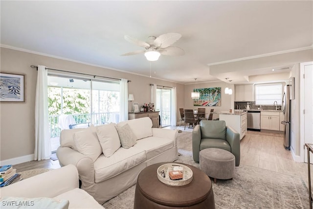 living room with ornamental molding, sink, ceiling fan, and light wood-type flooring